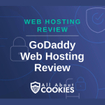 A blue background with images of locks and shields and the text &quot;GoDaddy Web Hosting Review&quot;