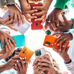 Teens holding cell phones in a circle