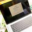 MacBook Air M4 is shown during initial setup process with Apple ID login screen visible.