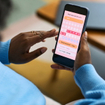 Woman using smartphone to track menstrual cycle.