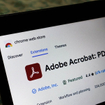 Laptop screen displaying the Adobe Acrobat extension page on the Chrome web store.