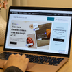 Closeup of laptop with GoDaddy Airo website 