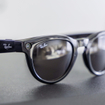 Close-up of black Meta Ray-Ban smart glasses featuring a camera lens.