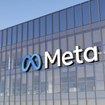 Meta logo on side of glass office building.