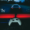 A video game controller sitting in front of a monitor