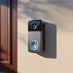 Smart video doorbell installed beside residential front entrance door.