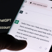 ChatGPT chat bot screen seen on smartphone and laptop display with Chat GPT login screen on the background.