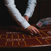 A blackjack table dealer dealing.