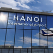 Hanoi International Airport sign on side of building.