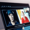 Computer analyzing a man's face and matching it to other photographs of him.