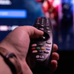 closeup of hand holding an LG smart TV remote