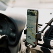 A phone open to Google Maps mounted in a car.