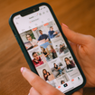 A well-manicured pair of hands holds a phone open to TikTok.