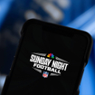 A closeup of a smartphone displaying Sunday Night Football and NBC and NFL emblems