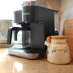 Closeup shot of a coffee station with a Keurig coffee machine in a kitchen.