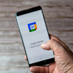 A Mobile phone or cell phone being held showing the Google Calendar app open on screen