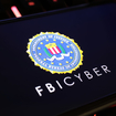 Smartphone screen with logo lettering of FBI Cyber.