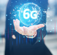 Hand open with floating globe with blue lights connecting and in the middle 6G