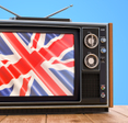An old TV set displays the British flag on the screen to represent watching BBC iPlayer with Surfshark VPN.
