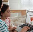 Mom installing parental control on laptop at home.