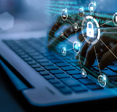 A person typing on a computer with abstract icons for security and other computer features above their hands.