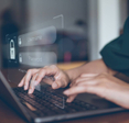 Woman typing on computer user and password login on visual screen.