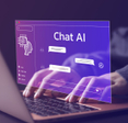 A person typing at a computer. A transposed image of the computer screen says Chat AI and shows a messaging screen.