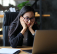 Woman looking at laptop worried
