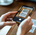 Woman scanning QR code with her phone