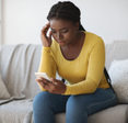 Woman looking concerned at her phone