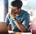 Man looking frustrated at computer