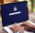 A user logging in to a password protected laptop.