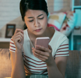 Woman looking skeptically at her phone