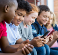 A group of kids watch videos on their iPhones.