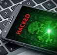 skull of death on smartphone screen. Hacked mobile phone on laptop computer
