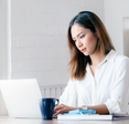 A woman types on her computer. 