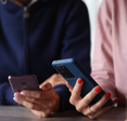 Two Android users holding their phones