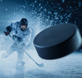A close up of a hockey puck hurling toward the fore