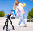 Teenage girl filming TikTok video of herself on mobile phone