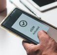 A person&#x27;s mobile phone displaying &quot;eSIM activated&quot;
