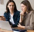Two people at a laptop