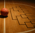 A basketball on a court with itsshadow forming a tournament bracket