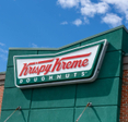 Close up of a Krispy Kreme sign on building