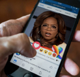 Oprah ad on Facebook with person hitting love heart icon