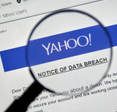 Closeup of a magnifying glass displaying a Yahoo data breach notice