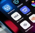 Assorted website builder apps on smartphone