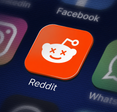 The Reddit app icon with Xs over the eyes.