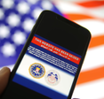 Phone screen showing a website has been seized by the FBI.