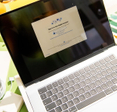 MacBook Air M4 is shown during initial setup process with Apple ID login screen visible.