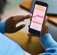Woman using smartphone to track menstrual cycle.